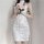 Woman in white lace cheongsam sleep dress with side ties, holding a pink rose.
