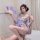 Woman in sheer butterfly-print kimono robe, braless design, holding purple fan—seductive sleepwear for women.