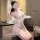 Woman kneeling in a sheer white lace bodysuit with floral embroidery, wearing the summer sexy sheer lace bodysuit set.