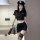 Woman in black police uniform lingerie set with short skirt, cap, and whip for naughty officer role play.