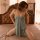 Woman wearing suoqing sexy lace sleep dress with slit and adjustable straps, posing on bed in sensual plus size nightwear.