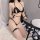 Woman in black suoqing sexy lingerie set with garter belt and thigh strap, posing on white rug beside balloons.