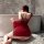 A woman sits by a bathtub wearing a red tang dynasty style sensual backless hanfu costume set, perfect for exotic court dance...