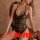 Woman wearing a black sheer lace bodysuit with an open-crotch design, featuring a backless and tight-fit style for a seductiv...