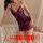 Woman wearing purple lace sleepwear set with sheer details and bow accents, designed for intimate nights and role play.