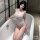 Woman in bathtub wearing sexy sheer mesh bodysuit with ripped lace cut-outs and tight-fit design.