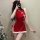 A woman poses in a festive red cheongsam outfit, featuring sheer bust design and white fur trim. the dress includes playful p...
