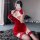 A woman poses in a red lace cheongsam lingerie set, featuring stockings and gloves, perfect for festive occasions or elegant ...