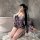A woman poses in a bathroom wearing yasise night fantasy lingerie, featuring a deep v neckline and kimono-style floral design...