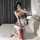 A woman poses on a bed wearing a charming maid-themed sleepwear costume by yimengyao. the outfit features a plaid top with la...