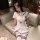 A stylish young woman wears a chic ysuzimei jk sailor uniform, featuring a white dress with blue accents, perfect for a schoo...