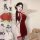 A woman poses elegantly in a zimei red silk velvet chinese-style lingerie set, featuring traditional knotted buttons and shee...