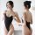 A woman models a sleek black one-piece swimsuit with thin straps, open back design, and high neck, showcasing its elegant fit...